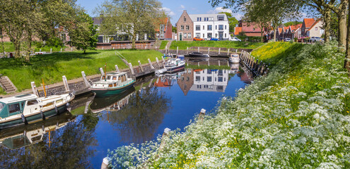 Panorama of spring flowers at the historic canal of Vollenhove, Netherlands