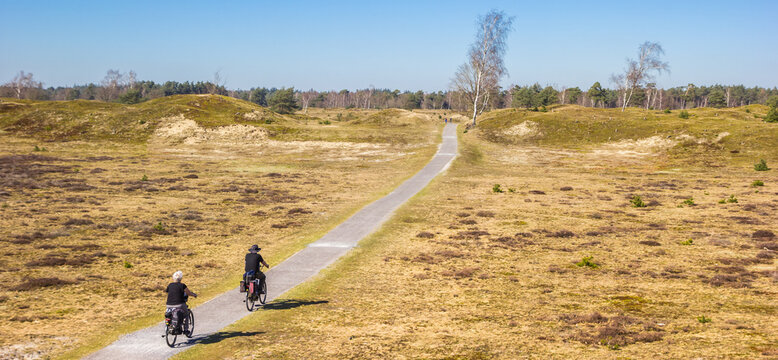 Panorama of a senior couple on bicycles in the national park Drents-Friese Wold, Netherlands