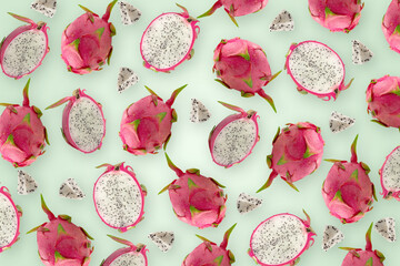 Dragonfruit with half on green wallpaper background