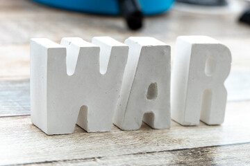 Word War with concrete letters isolated on a simple background