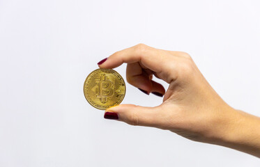 Fototapeta premium A bitcoin coin in a woman's hand