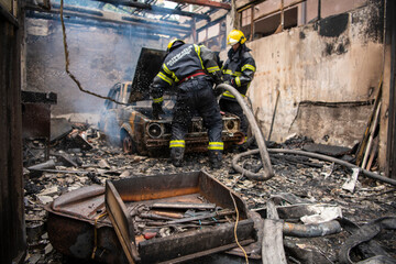 Closeup. Tool box lying on the ground in front of burned old retro car. Explosion and fire disaster...