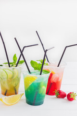 Summer lemonade group plastic cup ice cold white background