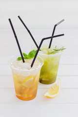 Fototapeta premium Lemonade citrus non-alcoholic cocktails white wooden background.