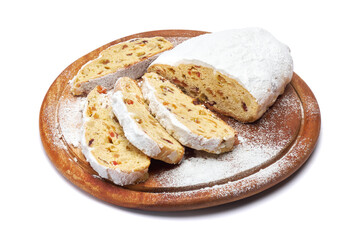 Sliced Traditional Christmas stollen cake with marzipan and dried fruit isolated on white background