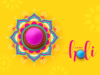 Indian festival of colours, Happy Holi concept, a traditional pot with full of dry colours(gulal) on beautiful mandala(rangoli) and vibrant yellow background. - obrazy, fototapety, plakaty