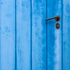 Blue painted door closeup with simple handle, plenty of space for text or logo