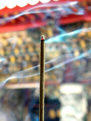 Burning incense in the temple is a religious ceremony to worship the Buddha. (the background is...
