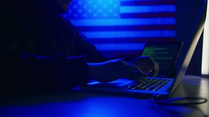 Hacker with laptop and USA flag in background. Cyber attack concept. - Powered by Adobe