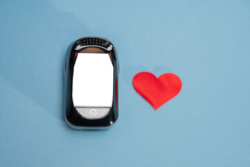 The device is a heart rate monitor on a blue background with a place for text and a cut-out place...
