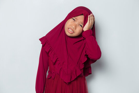 sick muslim asian little girl with headache and problems
