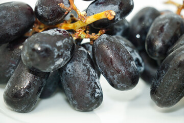 Black grapes with drop of water isolated on white background very attractive