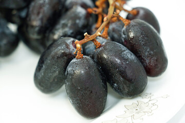 Black grapes with drop of water isolated on white background healthy fruits