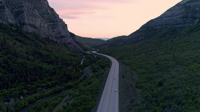 Aerial view of road through Provo Canyon with traffic during sunset along the Provo River.