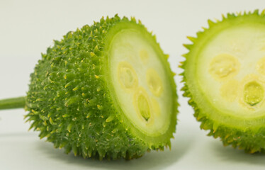 Green spiny gourd kakrol vegetable on white background