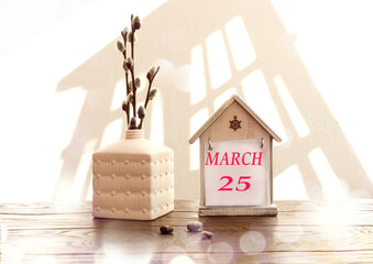 Calendar for March 25: a decorative house with the name of the month March in English, the numbers...