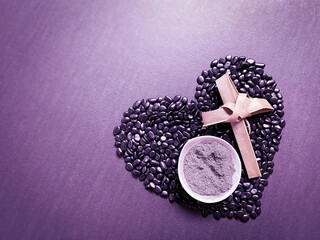 Lent Season,Holy Week and Good Friday Concepts - image of bowl of ash with cross made of palm leave on heart shaped background. Stock photo.