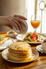 traditional Russian pastries: pancakes for Maslenitsa, pancakes with salmon, pancakes with honey, pancakes for breakfast