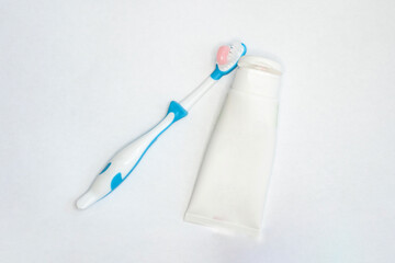 toothbrushes for adults and children and a tube of paste on an isolated white background. with a place to insert text.