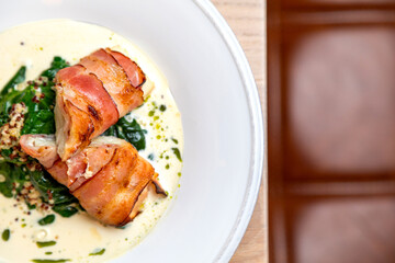 fried bacon rolls with sauce and herbs