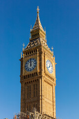 Fototapeta na wymiar The Elizabeth Tower in Westminster, commonly known as Big Ben, against a blue sky.