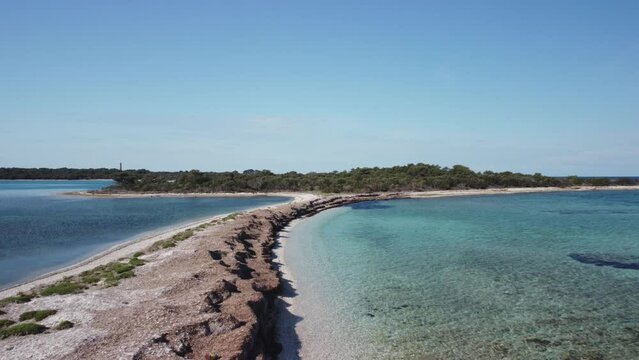 Natural Mediterranean lagoon with crystal blue sea and seagrass filmed from the air, 4K drone footage in Dugi otok, Croatia