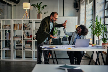 Two business people high-five. Job well done