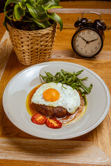 breakfast fried eggs with beefsteak, arugula and sun-dried tomato