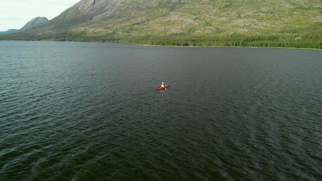 Aerial drone 4K shot of kayaker padling over a lake
