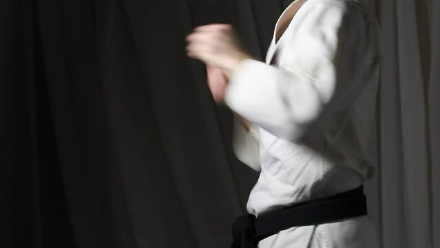 With a black belt the athlete beats punches