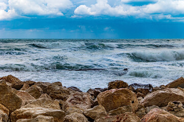 Huge waves crash against the rocks