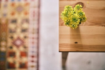 beautiful yellow flower on wooden table