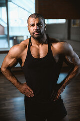 Fototapeta na wymiar Close up portrait of African American muscular man at gym.
