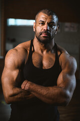 Fototapeta na wymiar Close up portrait of African American muscular man at gym.