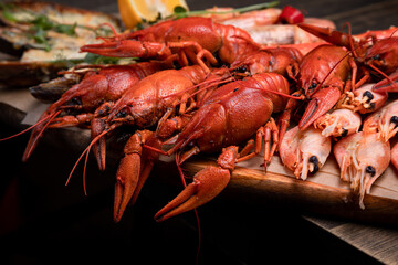 a plate of various snacks, seafood, mussels, boiled crayfish, shrimps