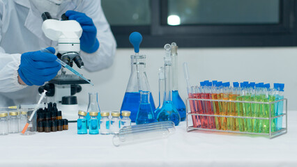 Researchers, doctors, scientists work with plastic medical tubes in modern laboratories or...