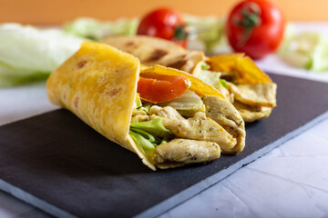 Chicken wrap with salad and tomato. Idea for a tasty and healthy lunch.