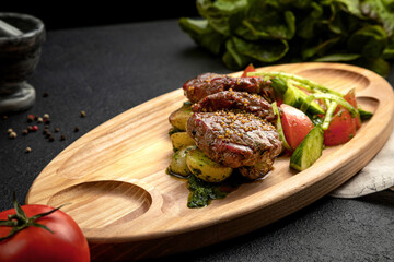 steak served on a wooden tray with fresh vegetables