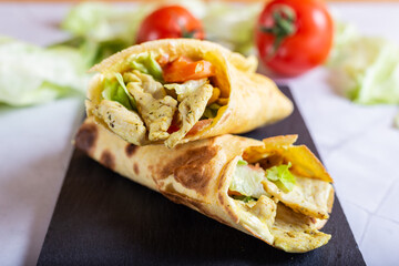 Chicken wrap with salad and tomato. Idea for a tasty and healthy lunch.