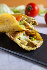 Chicken wrap with salad and tomato. Idea for a tasty and healthy lunch.