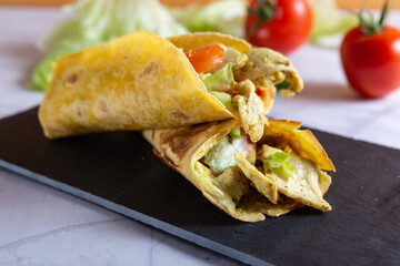 Chicken wrap with salad and tomato. Idea for a tasty and healthy lunch.