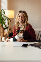 Portrait of smiling woman in red jacket and her dog, happily looking at the camera.