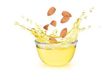 Fototapeta na wymiar Almond oil splash in glass bowl and almonds nuts isolated on white background.