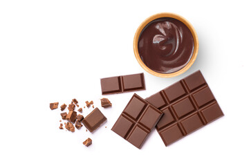 Dark chocolate cream in wooden bowl and broken pieces of chocolate bar isolated on white...