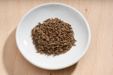 Detailed and large close up shot of caraway on a small plate