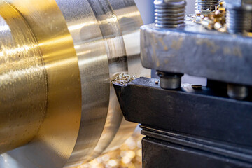 The work of a lathe in the production of non-ferrous metal products. Soft focus