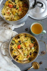 Delicious homemade Indian cuisine. Chicken Curry Potato Briyani. Healthy meal of basmati rice with curried potato cubes, chicken breast meat, diced cucumber, raisins, parsley and cherry tomatoes.
