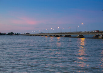 Fototapeta na wymiar Bridge over a river or sea at dusk or twilight