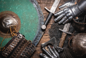 Medieval concept flat lay background. Sword, armor, helmet and shield background.