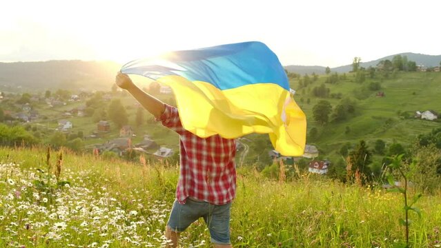 A man with the flag of Ukraine on the background of mountains. Independent of Ukraine.